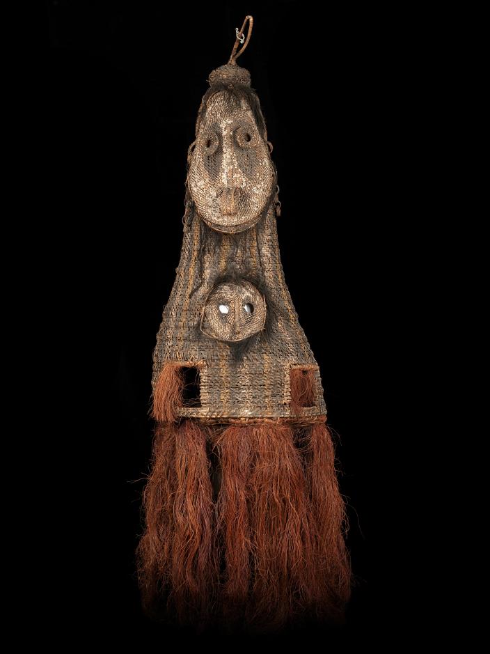 A double faced, tall woven dance mask from Kanganaman Village. The mask has two 